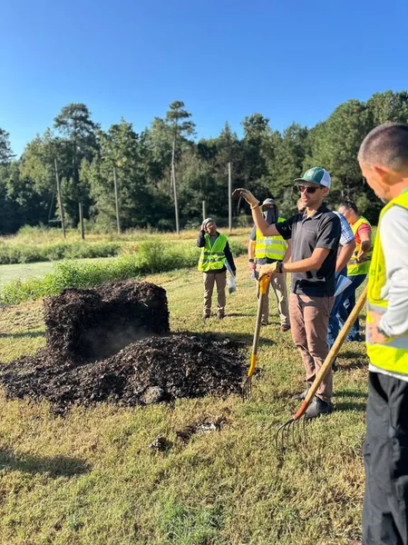 Jorge Montezuma demonstrating composting outdoors